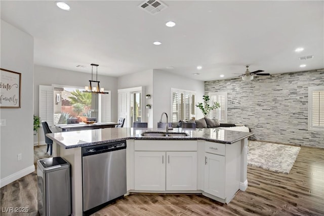 5742 Shadow Bend Dr, Las Vegas, NV 89135 - kitchen featuring stainless steel dishwasher, a sink, open floor plan, stone counters, and recessed lighting