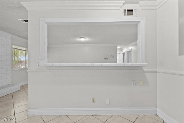 5101 Churchill Ave, Las Vegas, NV 89107 - unfurnished room featuring ornamental molding, light tile patterned flooring, a textured ceiling, and baseboards