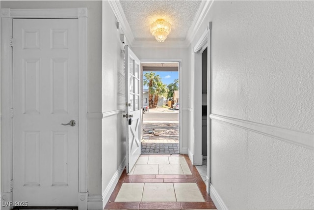 5101 Churchill Ave, Las Vegas, NV 89107 - doorway to outside with ornamental molding, a textured wall, light tile patterned flooring, and a textured ceiling