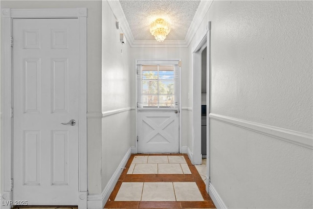 5101 Churchill Ave, Las Vegas, NV 89107 - doorway to outside with tile patterned floors, inlaid floor details, baseboards, crown molding, and a textured ceiling