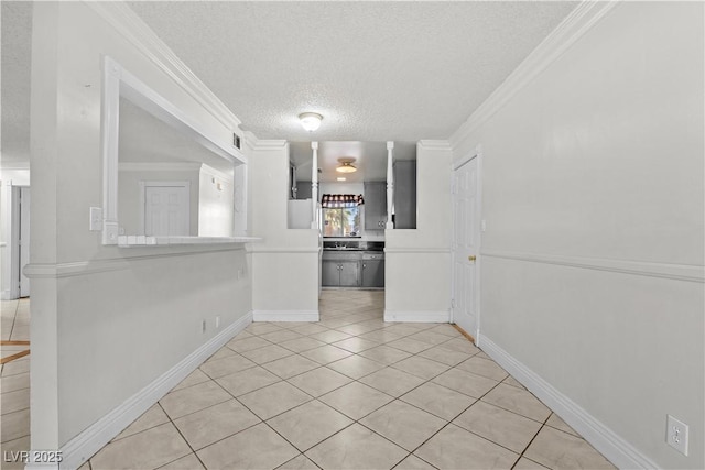 5101 Churchill Ave, Las Vegas, NV 89107 - spare room featuring a textured ceiling, light tile patterned flooring, ornamental molding, and baseboards