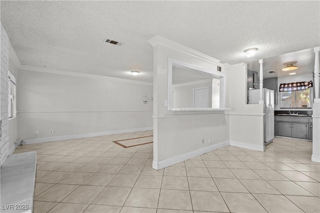 5101 Churchill Ave, Las Vegas, NV 89107 - unfurnished room featuring a textured ceiling, light tile patterned floors, crown molding, baseboards, and a sink