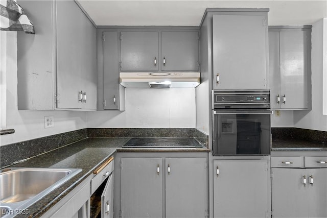 5101 Churchill Ave, Las Vegas, NV 89107 - kitchen with black appliances, under cabinet range hood, and gray cabinetry