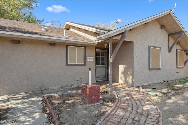 5101 Churchill Ave, Las Vegas, NV 89107 - doorway to property featuring stucco siding and a shingled roof
