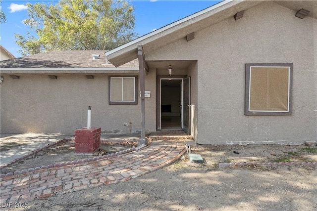 5101 Churchill Ave, Las Vegas, NV 89107 - entrance to property featuring stucco siding, roof with shingles, and a patio