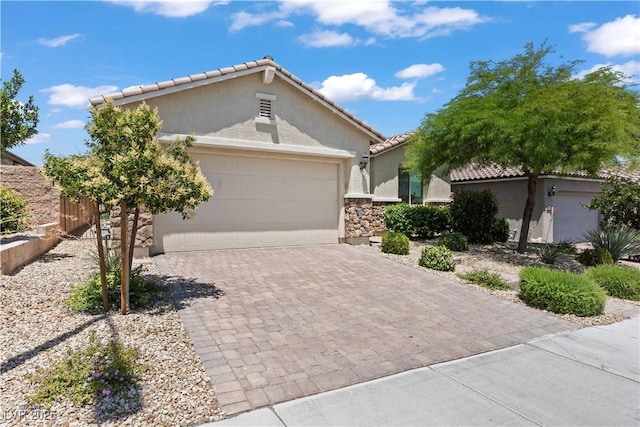 10416 Skye Arroyo Ave, Las Vegas, NV 89166 - ranch-style house with a tile roof, stucco siding, decorative driveway, an attached garage, and stone siding