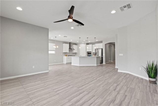 10416 Skye Arroyo Ave, Las Vegas, NV 89166 - unfurnished living room with a ceiling fan, arched walkways, recessed lighting, and baseboards