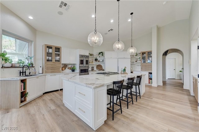 2345 Villandry Ct, Henderson, NV 89074 - kitchen featuring open shelves, a spacious island, a kitchen bar, white cabinets, and recessed lighting