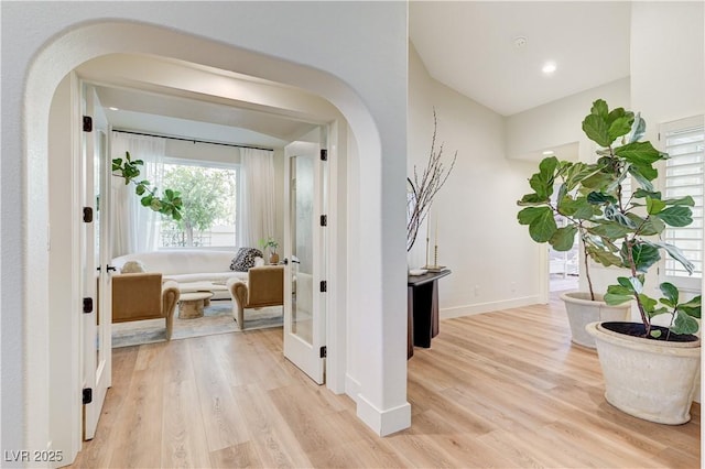 2345 Villandry Ct, Henderson, NV 89074 - hallway with arched walkways and light wood-style floors