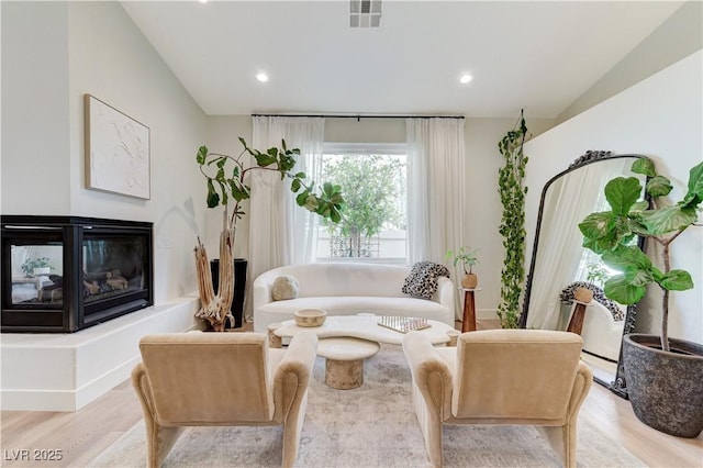2345 Villandry Ct, Henderson, NV 89074 - living room featuring wood finished floors, a multi sided fireplace, and recessed lighting