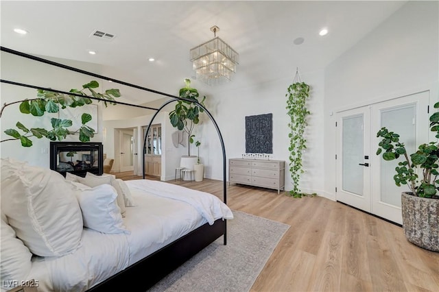 2345 Villandry Ct, Henderson, NV 89074 - bedroom with french doors, light wood-style floors, recessed lighting, and a chandelier