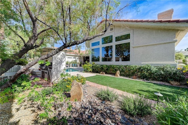 2345 Villandry Ct, Henderson, NV 89074 - rear view of property featuring a yard, stucco siding, and a tiled roof
