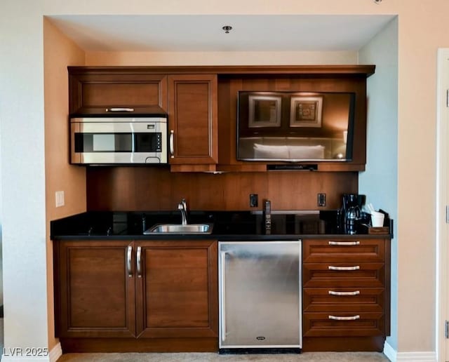 145 E Harmon Ave Unit 2409, Las Vegas, NV 89109 - kitchen with a sink, stainless steel microwave, refrigerator, and dark countertops