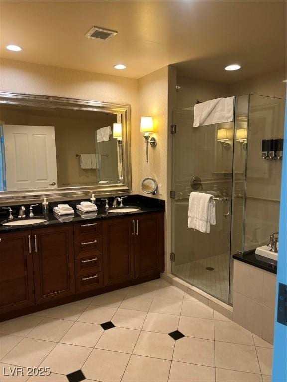 145 E Harmon Ave Unit 2409, Las Vegas, NV 89109 - bathroom with double vanity, a shower stall, tile patterned floors, and recessed lighting