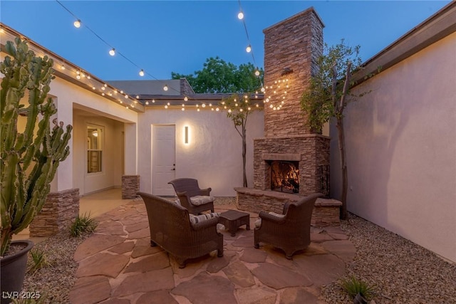 48 Panorama Crest Ave, Las Vegas, NV 89135 - view of patio / terrace featuring an outdoor stone fireplace