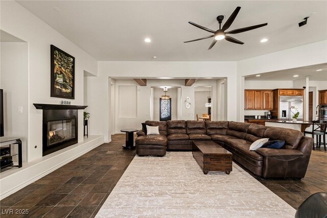 48 Panorama Crest Ave, Las Vegas, NV 89135 - living area featuring a ceiling fan, recessed lighting, a glass covered fireplace, and dark stone finish floors
