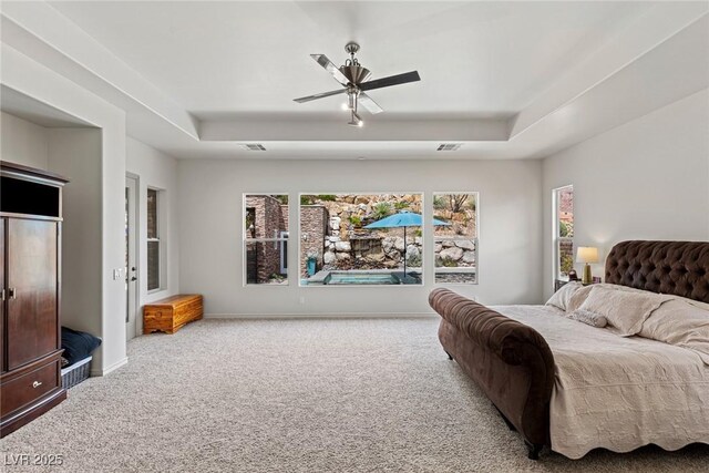 48 Panorama Crest Ave, Las Vegas, NV 89135 - bedroom featuring a tray ceiling, carpet floors, a ceiling fan, and baseboards