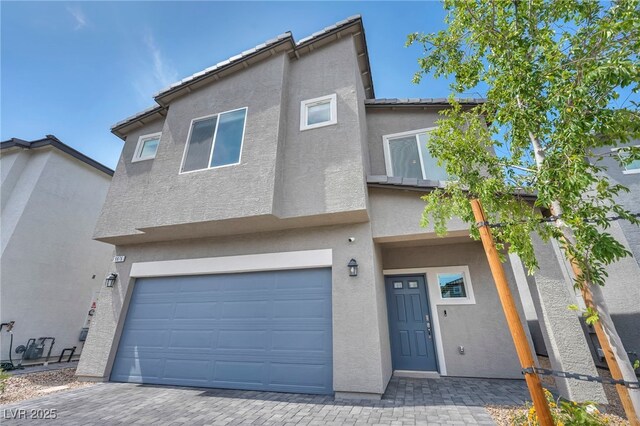 9876 Magnus Ct, Las Vegas, NV 89178 - view of property with stucco siding, an attached garage, and driveway