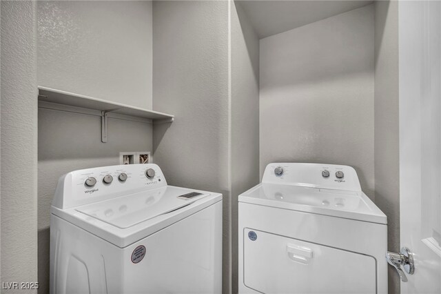 9876 Magnus Ct, Las Vegas, NV 89178 - laundry area featuring separate washer and dryer and a textured wall