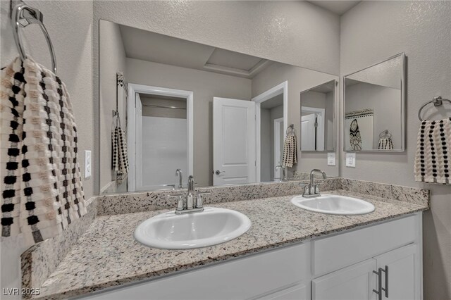 9876 Magnus Ct, Las Vegas, NV 89178 - bathroom featuring double vanity and a textured wall