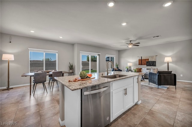 9876 Magnus Ct, Las Vegas, NV 89178 - kitchen with dishwasher, a sink, white cabinets, baseboards, and a kitchen island with sink