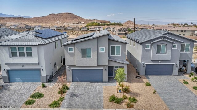 9876 Magnus Ct, Las Vegas, NV 89178 - view of front of house with an attached garage, a residential view, and stucco siding