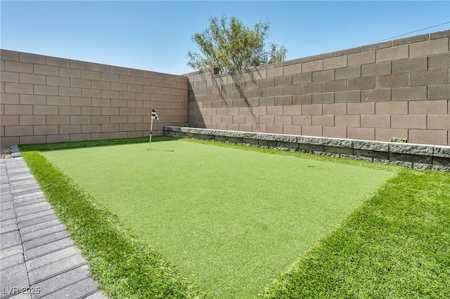 9876 Magnus Ct, Las Vegas, NV 89178 - fenced backyard featuring an area to practice putting