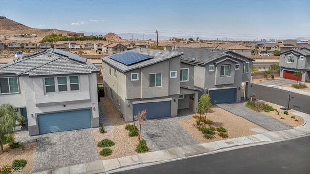 9876 Magnus Ct, Las Vegas, NV 89178 - view of front of home with an attached garage, a residential view, and stucco siding