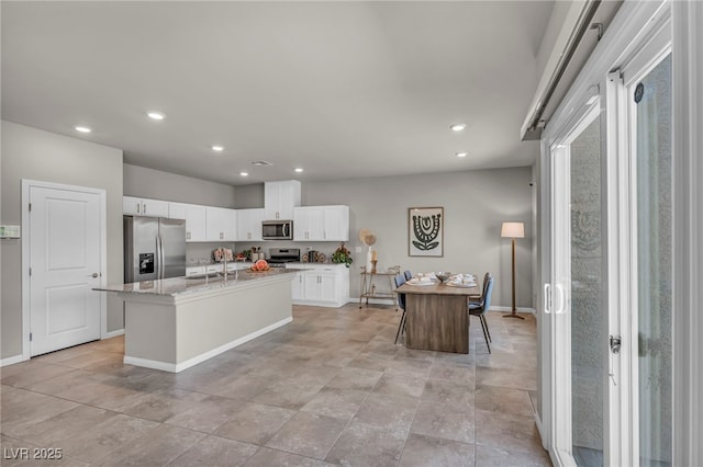 9876 Magnus Ct, Las Vegas, NV 89178 - kitchen with appliances with stainless steel finishes, a sink, recessed lighting, white cabinets, and baseboards