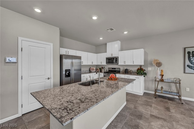 9876 Magnus Ct, Las Vegas, NV 89178 - kitchen featuring appliances with stainless steel finishes, a sink, baseboards, light stone counters, and white cabinets