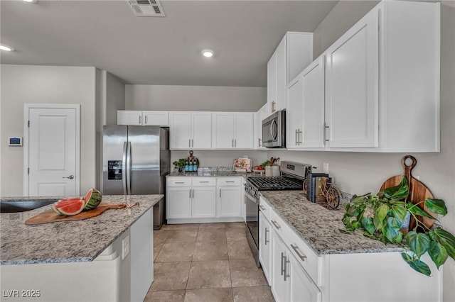 9876 Magnus Ct, Las Vegas, NV 89178 - kitchen featuring stainless steel appliances, white cabinetry, recessed lighting, and light stone countertops