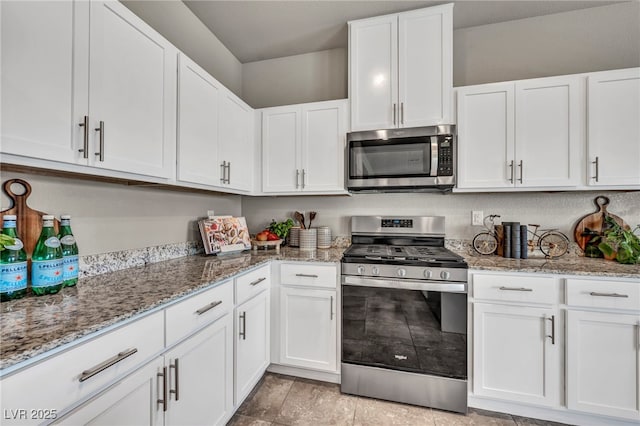 9876 Magnus Ct, Las Vegas, NV 89178 - kitchen featuring stainless steel appliances, white cabinets, and light stone counters