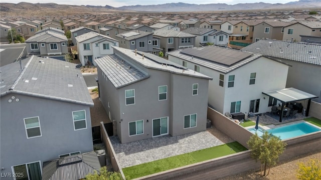 9876 Magnus Ct, Las Vegas, NV 89178 - rear view of property with a residential view, a mountain view, a fenced backyard, and stucco siding
