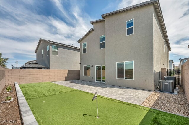 9876 Magnus Ct, Las Vegas, NV 89178 - rear view of property with a putting area, a patio, stucco siding, and a fenced backyard