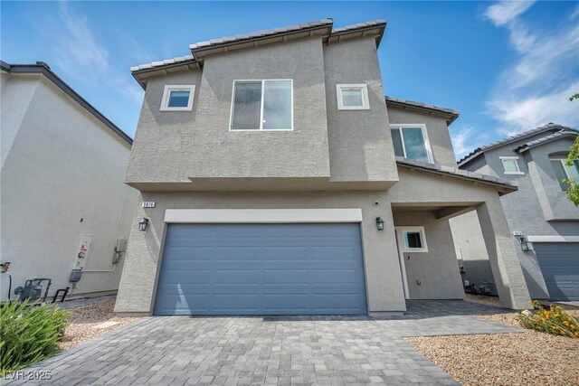 9876 Magnus Ct, Las Vegas, NV 89178 - view of front of property with stucco siding, an attached garage, and decorative driveway