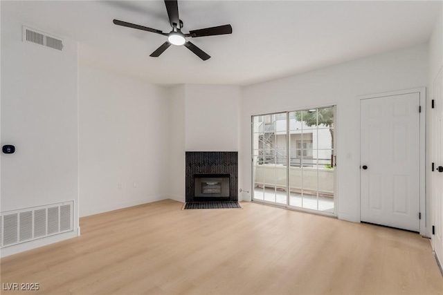 3318 N Decatur Blvd Unit 1020, Las Vegas, NV 89130 - unfurnished living room with light wood finished floors, ceiling fan, and a tile fireplace