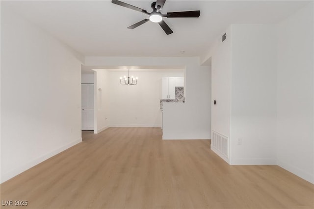 3318 N Decatur Blvd Unit 1020, Las Vegas, NV 89130 - unfurnished room featuring a chandelier, a ceiling fan, light wood-style floors, and baseboards