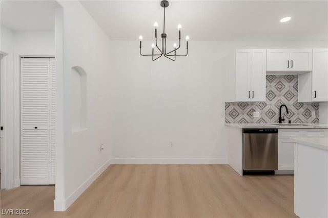 3318 N Decatur Blvd Unit 1020, Las Vegas, NV 89130 - kitchen featuring stainless steel dishwasher, a chandelier, light countertops, light wood-style flooring, and white cabinets