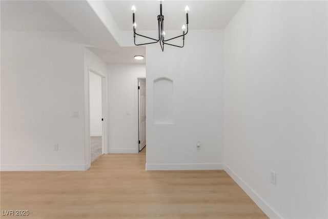 3318 N Decatur Blvd Unit 1020, Las Vegas, NV 89130 - unfurnished dining area featuring a chandelier, light wood finished floors, and baseboards