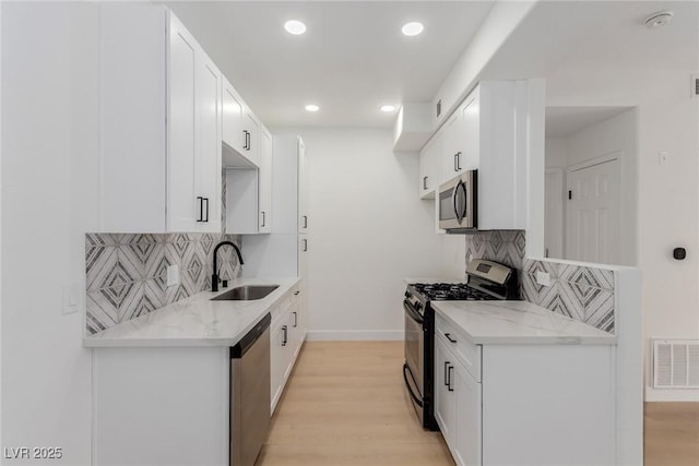 3318 N Decatur Blvd Unit 1020, Las Vegas, NV 89130 - kitchen featuring stainless steel appliances, a sink, tasteful backsplash, light stone countertops, and recessed lighting