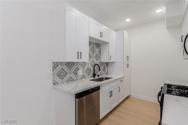 3318 N Decatur Blvd Unit 1020, Las Vegas, NV 89130 - kitchen with stainless steel appliances, a sink, decorative backsplash, white cabinets, and recessed lighting