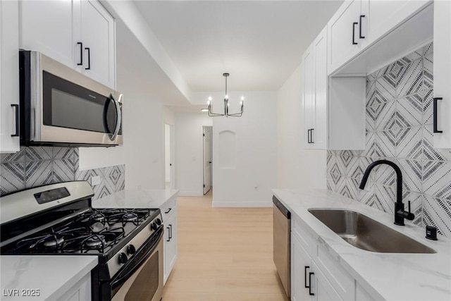 3318 N Decatur Blvd Unit 1020, Las Vegas, NV 89130 - kitchen with appliances with stainless steel finishes, a sink, tasteful backsplash, and white cabinets