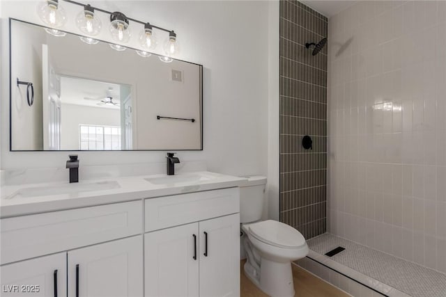 3318 N Decatur Blvd Unit 1020, Las Vegas, NV 89130 - full bath featuring double vanity, toilet, a tile shower, and ceiling fan