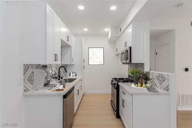 3318 N Decatur Blvd Unit 1020, Las Vegas, NV 89130 - kitchen with appliances with stainless steel finishes, a sink, decorative backsplash, light countertops, and recessed lighting