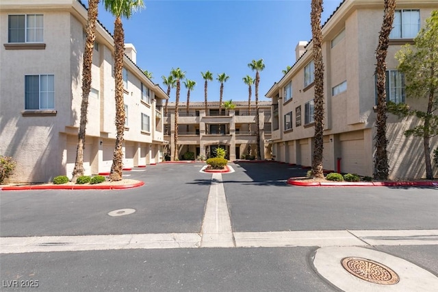 7151 S Durango Dr Unit 211, Las Vegas, NV 89113 - view of building exterior with uncovered parking and a residential view