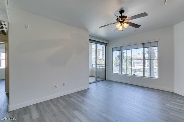 7151 S Durango Dr Unit 211, Las Vegas, NV 89113 - spare room with wood finished floors, baseboards, and ceiling fan