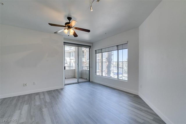 7151 S Durango Dr Unit 211, Las Vegas, NV 89113 - empty room with wood finished floors, baseboards, and a ceiling fan