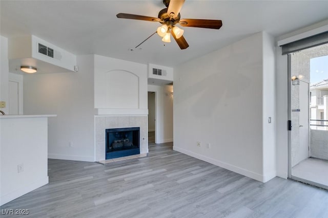 7151 S Durango Dr Unit 211, Las Vegas, NV 89113 - unfurnished living room featuring ceiling fan, light wood-type flooring, plenty of natural light, and baseboards