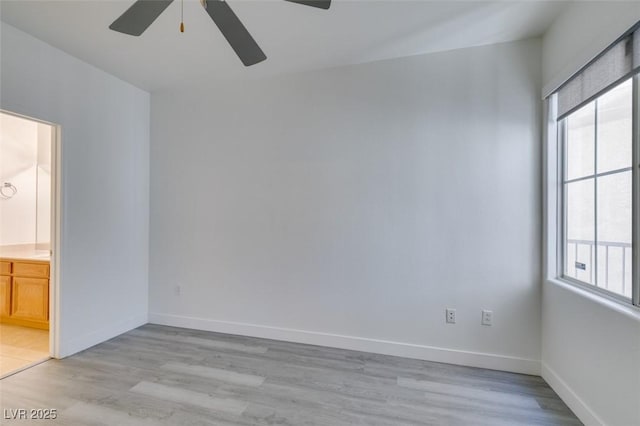 7151 S Durango Dr Unit 211, Las Vegas, NV 89113 - unfurnished bedroom with light wood-type flooring, ensuite bath, baseboards, and a ceiling fan