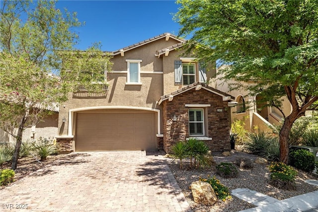 10474 Palmadora St, Las Vegas, NV 89178 - view of front facade with stucco siding, stone siding, a garage, decorative driveway, and a tile roof